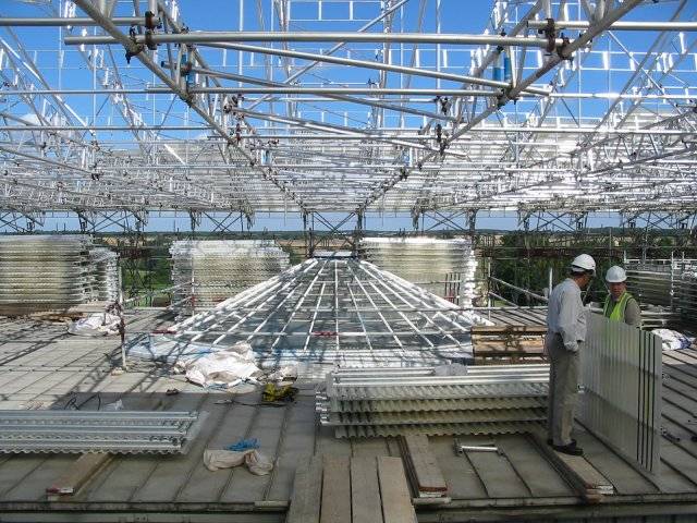 Scaffolding surrounds the glass dome on the roof of the Mable Saloon. Staff are tasked with removing large water tanks.